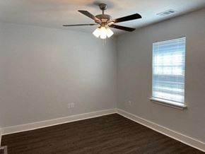Franklinton apartment for rent - A room with a ceiling fan and a window.