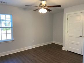 Franklinton apartment for rent - A room with a ceiling fan and a door.