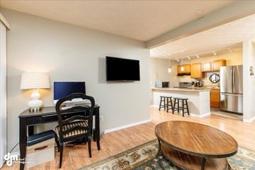 Anchorage apartment for rent - a living room and kitchen with a table and a tv