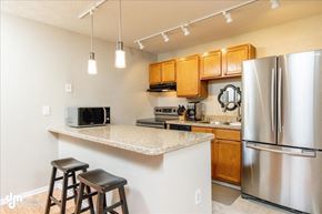 Anchorage apartment for rent - a kitchen with a counter top and a refrigerator