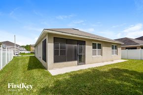 Clermont house for rent - a small tan house with a yard and grass
