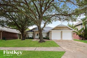 Humble house for rent - a house with a driveway and trees in front of it