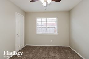Humble house for rent - a bedroom with carpet and a window and a ceiling fan