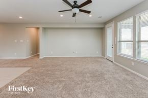 Katy house for rent - A spacious room with a carpeted floor and a ceiling fan.