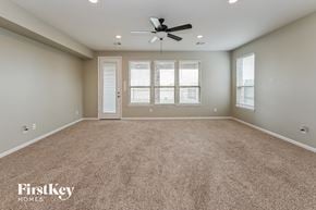 Katy house for rent - A spacious room with a carpeted floor and a ceiling fan.