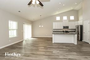 Murfreesboro house for rent - an open kitchen and living room with white cabinets and stainless steel appliances