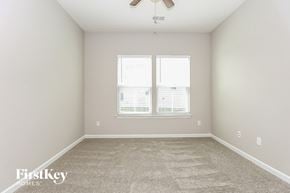 Murfreesboro house for rent - a bedroom with a carpeted floor and a window