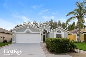 Wesley Chapel house for rent - a house with a driveway and a palm tree
