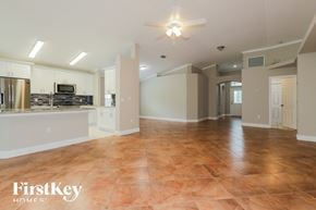 Wesley Chapel house for rent - an open kitchen and living room with tile flooring and a ceiling fan