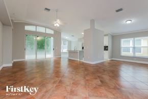 Wesley Chapel house for rent - an empty living room with a kitchen in the background