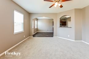 Cove house for rent - A spacious room with a ceiling fan and a large mirror on the wall.