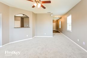 Cove house for rent - A spacious room with a ceiling fan and a mirror on the wall.