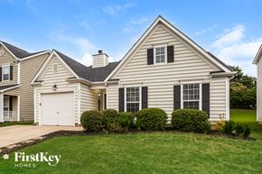 Charlotte house for rent - a home with a lawn and a garage