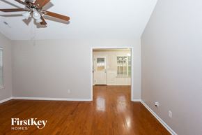 Charlotte house for rent - a living room with wood floors and a ceiling fan