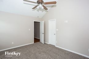 Charlotte house for rent - a bedroom with a ceiling fan and a door to a closet