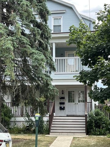 Summit apartment for rent - A blue house with a white door and a small porch.