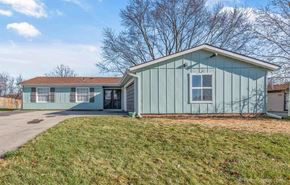 Bolingbrook house for rent - a green house with a driveway and a grassy yard