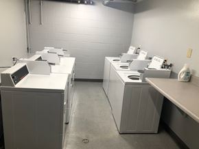 Long Beach apartment for rent - A row of washing machines are lined up in a laundry room.