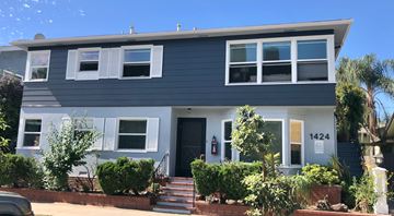 Long Beach apartment for rent - A two-story house with a grey facade and white trim.