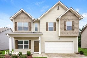 Braselton house for rent - a beige house with a white garage door
