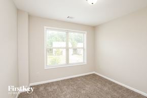 Braselton house for rent - a bedroom with a large window and a carpeted floor