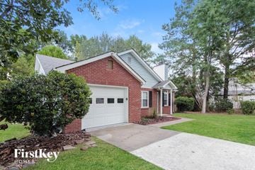 Charlotte house for rent - a small brick house with a white garage door