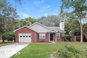 Charlotte house for rent - a brick house with a white garage door and a lawn