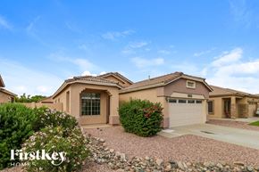 Surprise house for rent - a house with a garage and a driveway