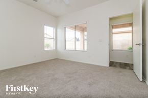 Surprise house for rent - a bedroom with a carpeted floor and two windows