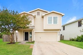 Cypress house for rent - a beige house with a driveway and a tree