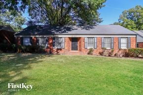 Memphis house for rent - a brick house with a lawn in front of it