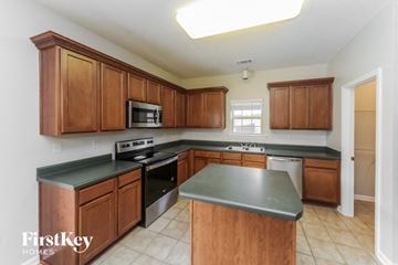 Olive Branch house for rent - a large kitchen with wooden cabinets and black counter tops