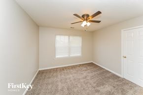 Olive Branch house for rent - a bedroom with a ceiling fan and a window