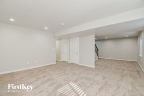 Fountain house for rent - A spacious room with a carpeted floor and a closet with a door.