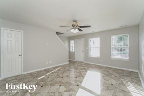 Charlotte house for rent - A spacious room with a fan and tiled flooring.