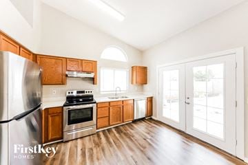 Surprise house for rent - A kitchen with wooden cabinets and a stainless steel refrigerator.