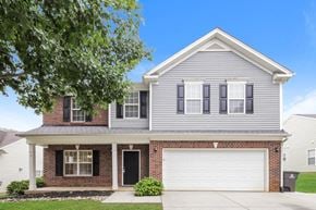 Winston-Salem house for rent - A two-story house with a garage and a brick base.