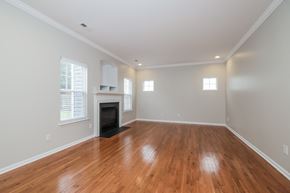 Winston-Salem house for rent - A room with wooden floors and a fireplace.