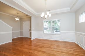 Winston-Salem house for rent - A room with wooden floors and a chandelier.
