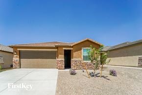 Tucson house for rent - a house with a driveway and a garage door