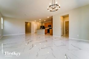 Tucson house for rent - an empty living room and kitchen with marble flooring
