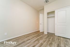 Tucson house for rent - a bedroom with a closet and a door to a wardrobe