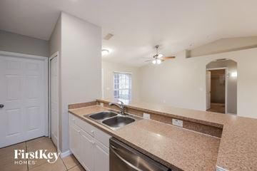 Lehigh Acres house for rent - a kitchen with granite counter tops and a stainless steel sink