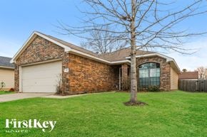 Conroe house for rent - A house with a tree in front of it.