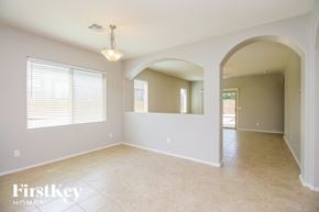 San Tan Valley house for rent - an empty dining room with white walls and tile floors