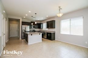 San Tan Valley house for rent - a large kitchen with black cabinets and a white counter top