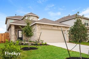 New Caney house for rent - A house with a brown roof and a garage door is for sale.