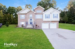 Clarksville house for rent - A house with a blue door and a garage is for sale.