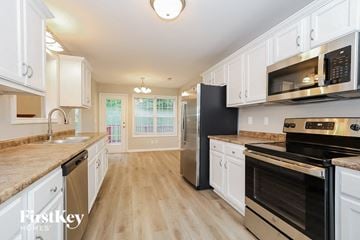 Clarksville house for rent - A kitchen with a black refrigerator and stainless steel appliances.