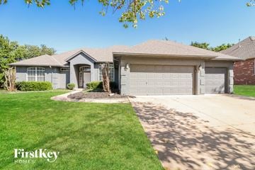 Edmond house for rent - a house with a driveway and a garage door